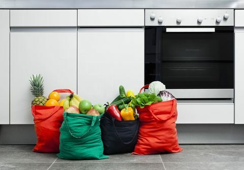 Επαναχρησιμοποιήσιμες σακούλες γεμάτες με φρούτα και λαχανικά σε μια κουζίνα.